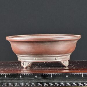 Brown ceramic bowl with ruler scale.
