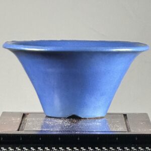 Blue ceramic pot on a measuring scale.