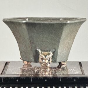 Bronze vessel with decorative animal face.