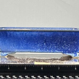 Blue rectangular ceramic bonsai pot, close-up.
